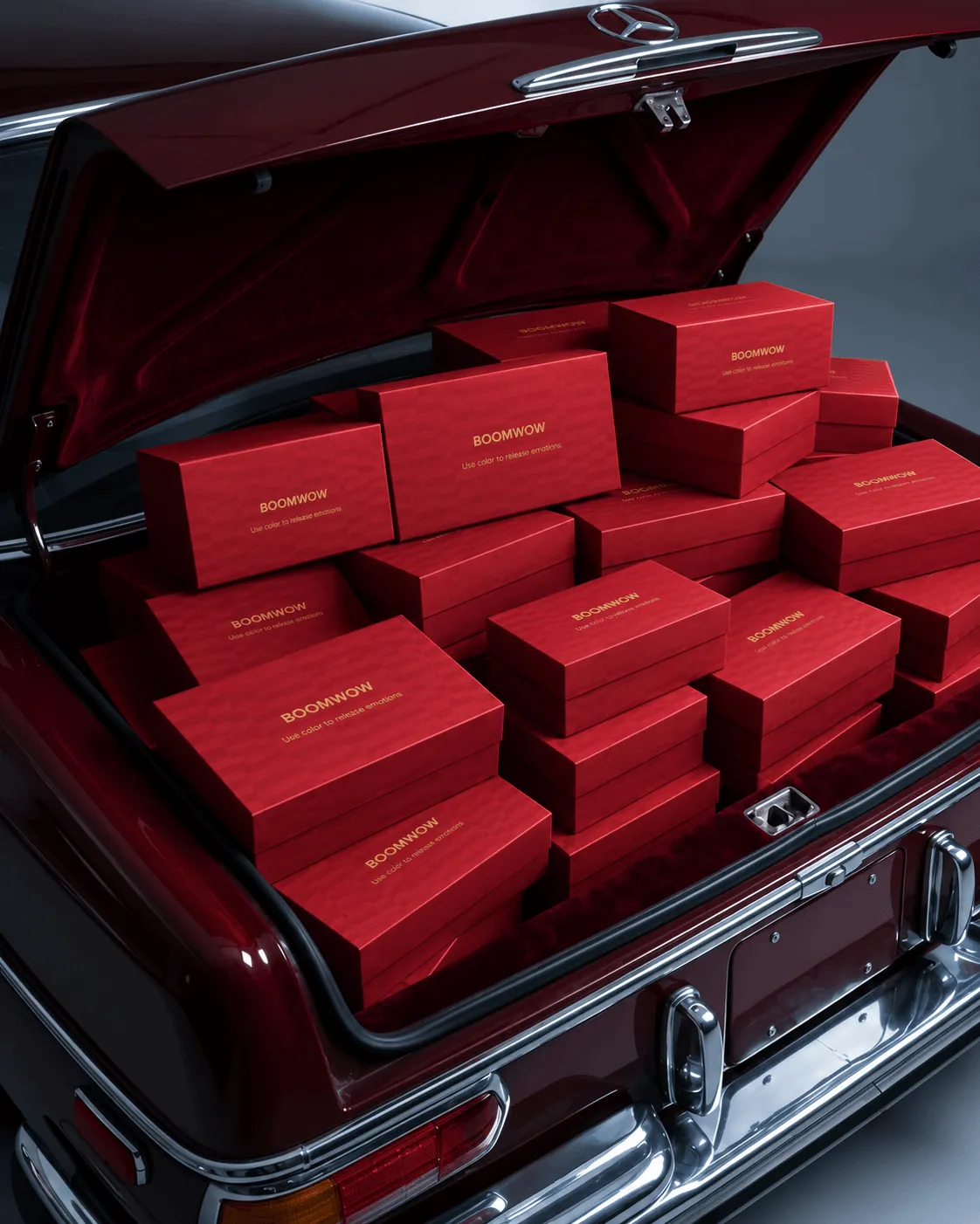 BOOMWOW gift boxes arranged in the trunk of a classic red car
